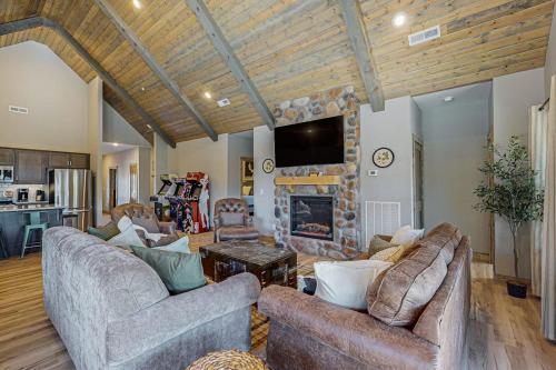 a living room with two couches and a fireplace at Cozy Cove Lodge in Branson