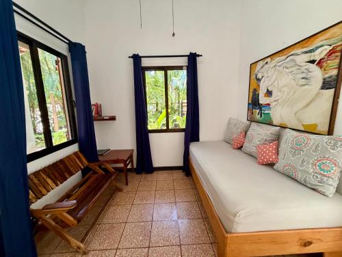 a living room with a couch and a window at Casita Gitza in Montezuma