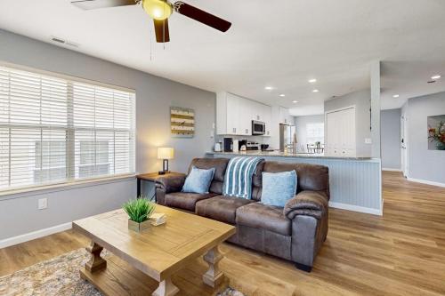 a living room with a brown couch and a table at Hole in One in Branson