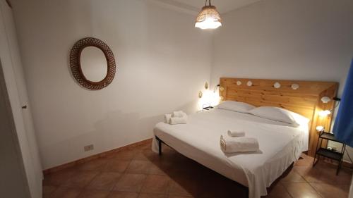 a bedroom with a large white bed with a mirror at Villetta Marausa - Birgi KITE in Marausa