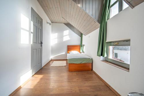 a small bedroom with a bed and a window at Red Stone in Kővágóörs