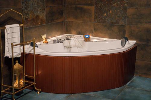 a large bath tub in a bathroom with at Red Stone in Kővágóörs