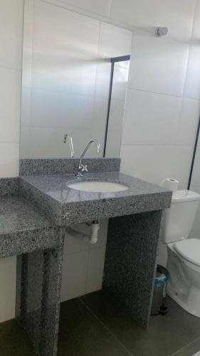 a bathroom with a sink and a toilet at Hotel AG3 in Teixeira de Freitas