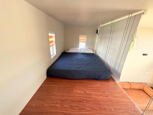 a bedroom with a bed in the corner of a room at Casa Guilligan By Los Naufragos in El Bateque