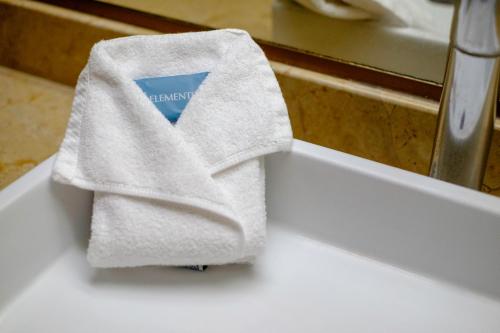 a white towel sitting on top of a sink at Hotel Laffayette Ejecutivo in Guadalajara