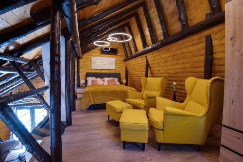 a bedroom with yellow chairs and a bed in a room at Villa Dodo in Soboli