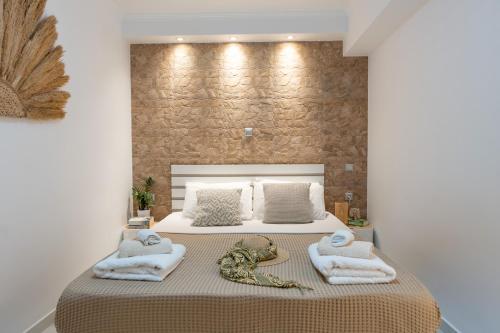 a bedroom with a bed with towels on it at Meraki Home in Lixouri