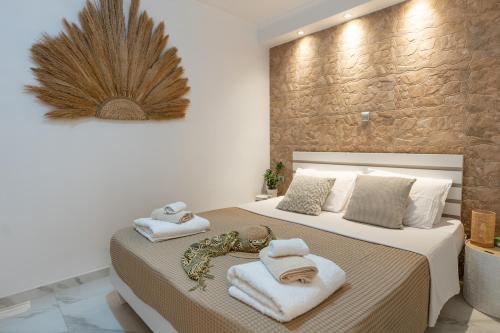 a bedroom with a bed with towels on it at Meraki Home in Lixouri
