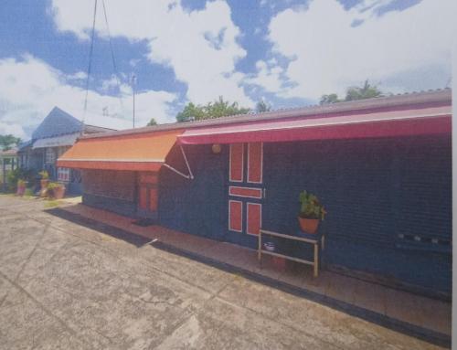 a building with a potted plant next to it at La vallée verte Martinique in Le Lamentin