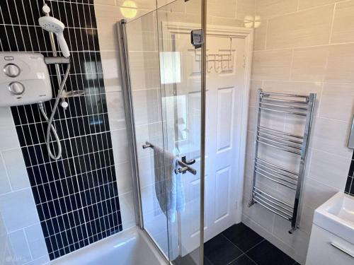 a shower with a glass door in a bathroom at 56 Woodlands in Clonakilty