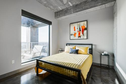 a bedroom with a bed and a large window at Sable 901 - Penthouse in Minneapolis