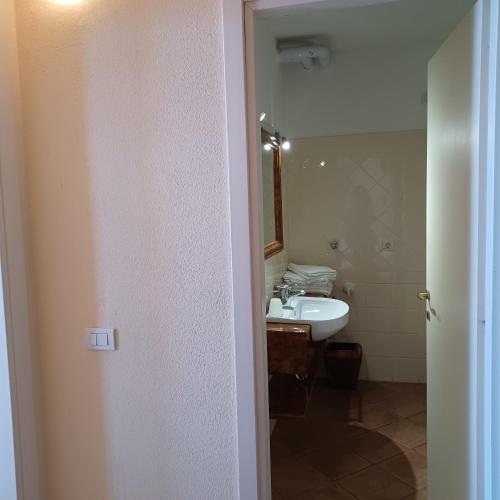 a bathroom with a sink and a mirror at Residence Il Vigneto in Oggebbio