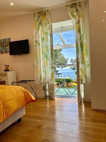 a bedroom with a bed and a sliding glass door at Villa Ice Sorrento in Sorrento