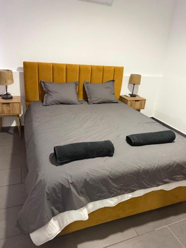 a large bed with two pillows on top of it at Venus sea view in Paphos