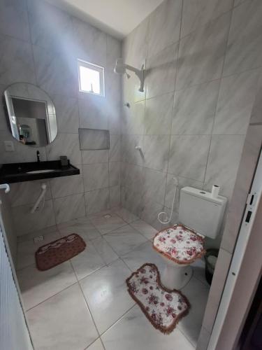 a bathroom with a shower and a toilet and a sink at Casa Lagoar in Jijoca de Jericoacoara