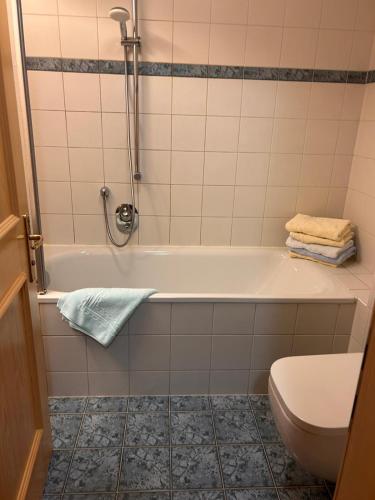 a bathroom with a tub and a toilet at Ganda Appartements in Gargellen