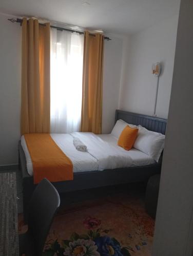 a small bedroom with a bed with a window at Shelvic Resort Ruiru in Ruiru