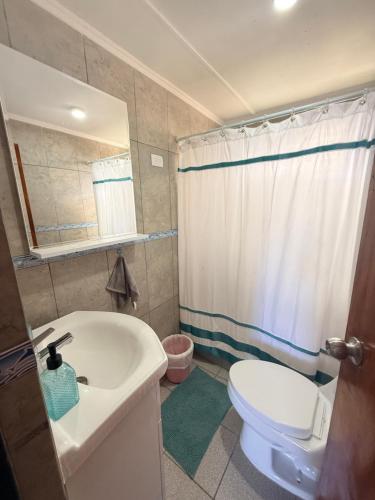 a bathroom with a tub and a toilet and a sink at Oasis terrenal Toconao in Toconao