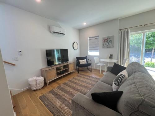 a living room with a couch and a flat screen tv at Minutes to Rock City, Ruby Falls, & Downtown in Chattanooga