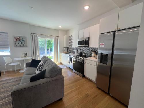 a kitchen with a couch and a stainless steel refrigerator at Minutes to Rock City, Ruby Falls, & Downtown in Chattanooga