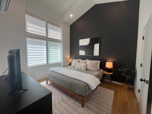 a bedroom with a bed and a flat screen tv at Minutes to Rock City, Ruby Falls, & Downtown in Chattanooga