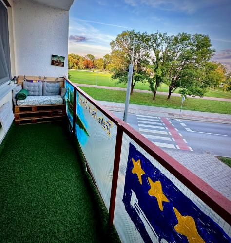 a balcony with a couch on the side of a building at Treba Malo Odmorit - PlayStation 5, Family Room, Free parking, Self check-in option in Karlovac