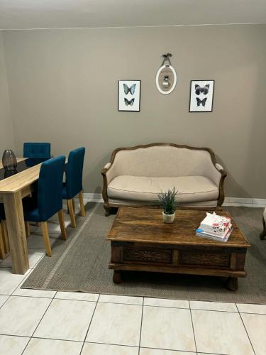 a living room with a couch and a coffee table at Apt Parisien in Vitry-sur-Seine