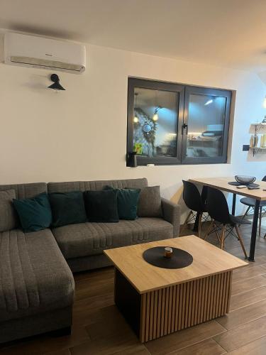 a living room with a couch and a table at Lighthouse Apartman in Svilajnac