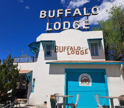a building with a blue door and a sign on it at Buffalo Lodge Bicycle Resort - Amazing access to local trails & the Garden in Colorado Springs