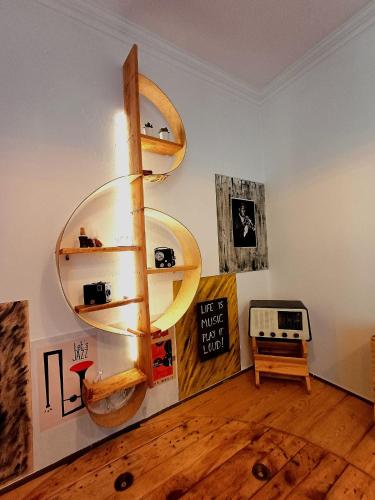 a living room with a wooden floor and shelves at Casa 40th-Music Wood House in Óbidos