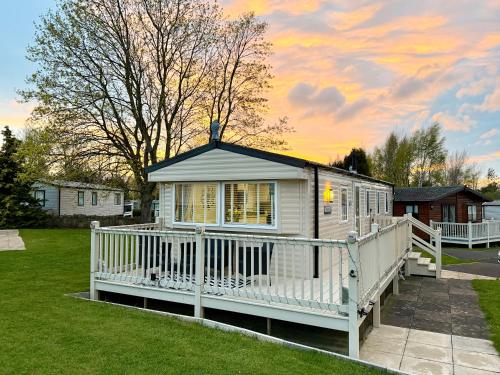 a small white house with a white deck at Rosie's Seton Retreat in Port Seton