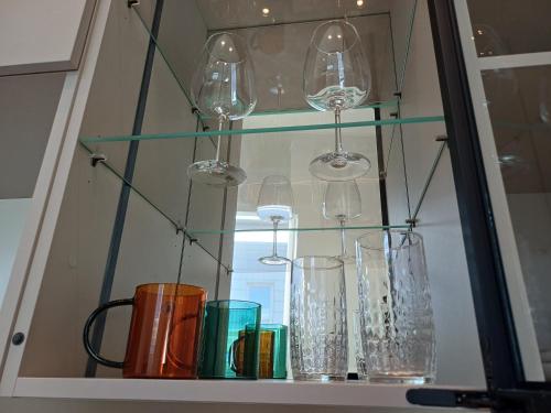 a shelf with several glass vases on it at Luise LuXe Suites in Tallinn