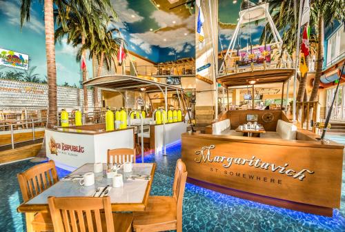 a restaurant with a table and chairs and a boat at Margaritaville Hollywood Beach Resort in Hollywood
