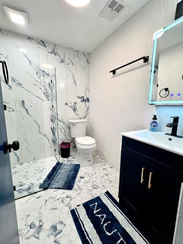a bathroom with a toilet and a sink and a mirror at Beach Front at Ft Myers Beach in Fort Myers Beach