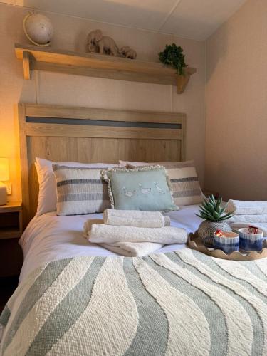 a bed with blankets and pillows on top of it at Snug on the Teviot in Hawick