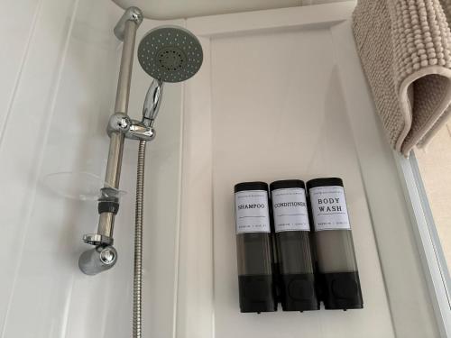 two bottles in a white drawer with a shower at Snug on the Teviot in Hawick
