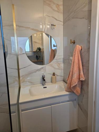 a bathroom with a sink and a mirror at Danka Riverside House in Livno