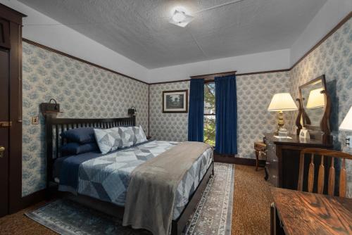 a bedroom with a bed and a table and a mirror at McCleary Hotel in McCleary