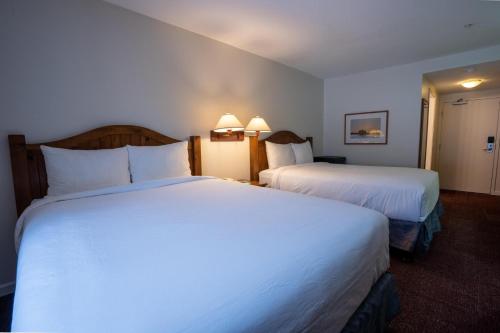 a hotel room with two beds with white sheets at Cahilty #211 home in Sun Peaks