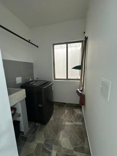 a bathroom with a toilet and a sink and a window at Apartamento completo cerca del centro in Montería