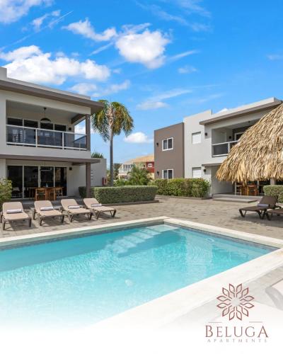 a swimming pool in front of a villa at Beluga Apartments Curacao - nabij Willemstad & Mambo Beach in Willemstad