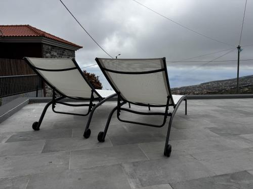 two chairs sitting on top of a roof at Hiking & Ocean in Arco da Calheta