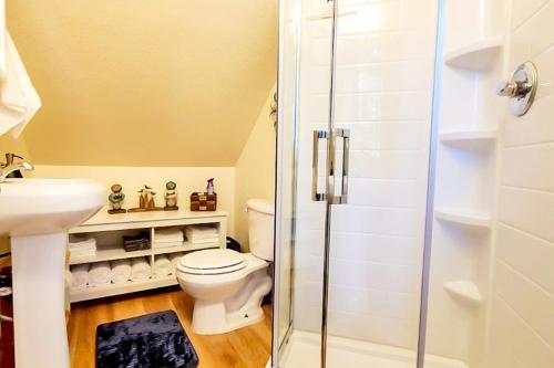 a bathroom with a toilet and a glass shower at Explore Caves & Coast! Family-Friendly Oregon Stay in Cave Junction