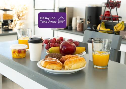 a plate of pastries and fruit on a counter at Moreno 820 by DOT Suites in Buenos Aires