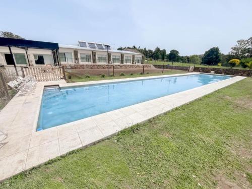 a swimming pool in the yard of a house at Hotel BIOCERRO in Tandil