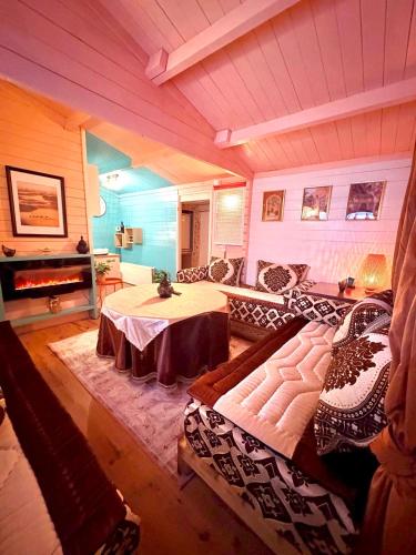 a living room with a table and a couch at 1001 Nights Luxury Spa Oasis with jacuzzi sauna and garden near Amsterdam in Vijfhuizen