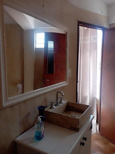 a bathroom with a sink and a large mirror at Rincon Del Colibri in Reyes