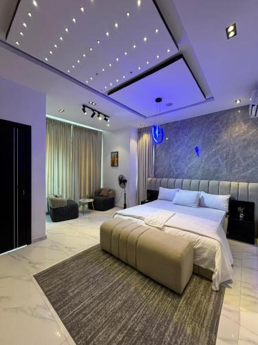 a bedroom with a large bed with purple lighting at Danjo Shortlets in Aja