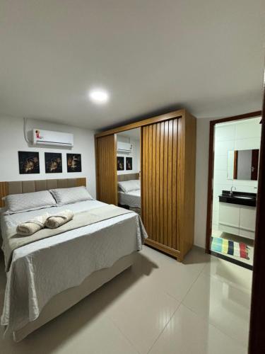 a bedroom with a large bed and a large window at Do mar ao Lar in Rio de Janeiro