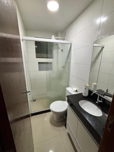 a bathroom with a toilet and a sink and a shower at Do mar ao Lar in Rio de Janeiro